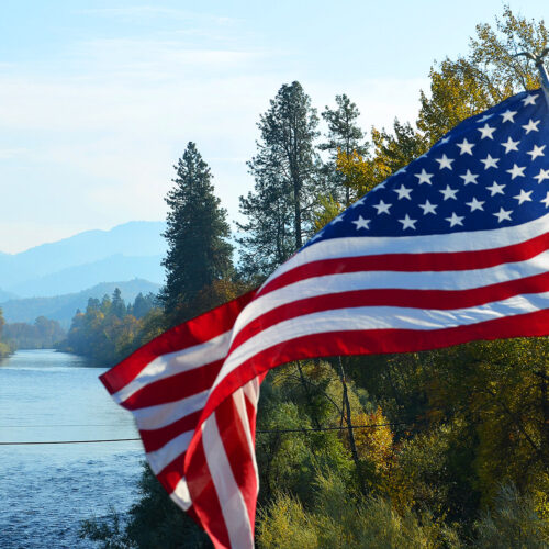 American flag over river